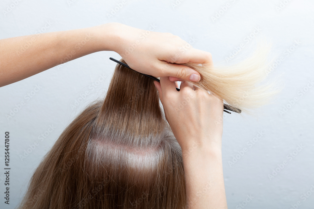 Naklejka premium Going gray in young woman shows her gray hair, hair roots getting grey. Problem of early graying, pigmentation changes. Mental health, stress