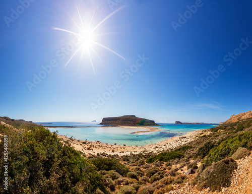 Scenic view of Balos Bay on the Gramvousa Peninsula in Crete, Greece with clear blue skies and sunshine photo