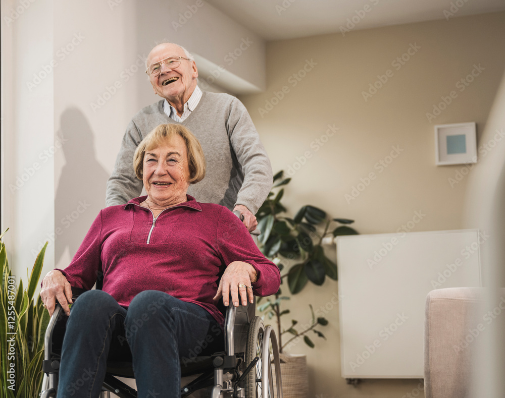Happy man with woman sitting in wheelchair Happy man with woman sitting in wheelchair