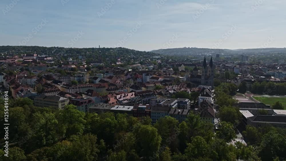 Aerial drone view of the Sanderau district in Würzburg, Germany, with the St. Adalbero Church prominently visible in the background, showcasing the charming residential areas and historical architectu Aerial drone view of the Sanderau district in Würzburg, Germany, with the St. Adalbero Church prominently visible in the background, showcasing the charming residential areas and historical architectu