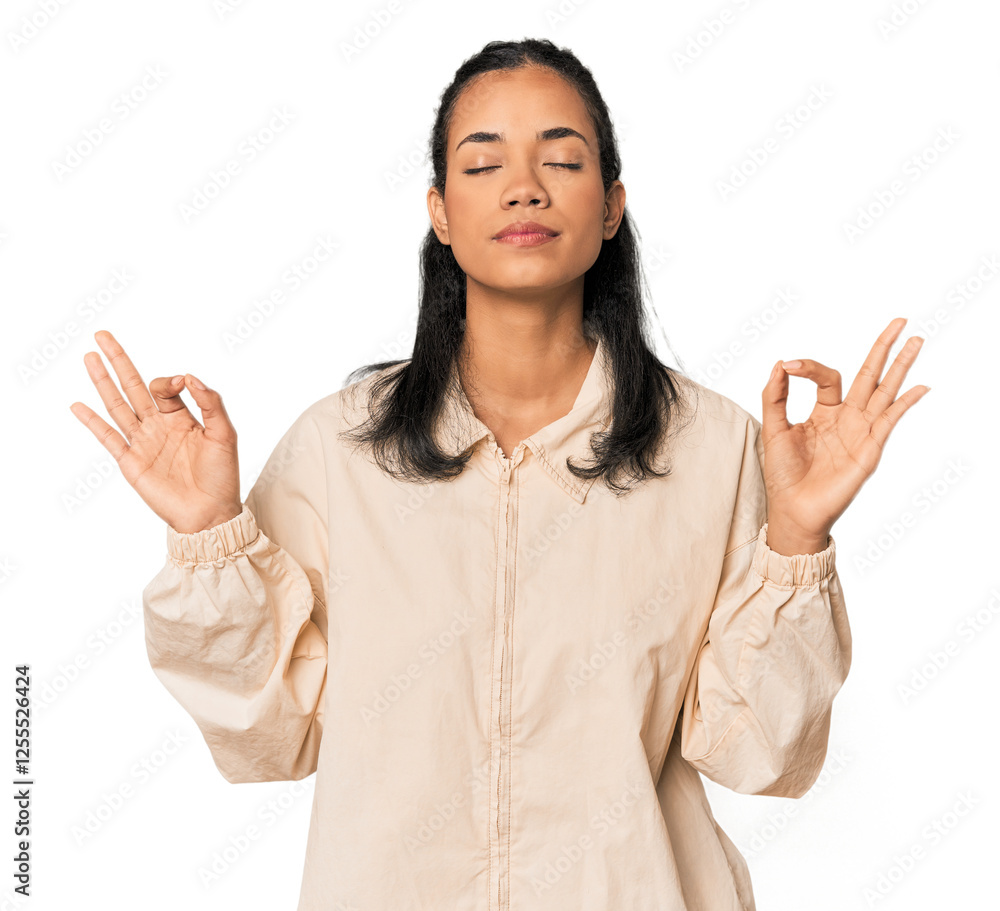 Young Filipina woman relaxes after hard working day, she is performing yoga. Young Filipina woman relaxes after hard working day, she is performing yoga.