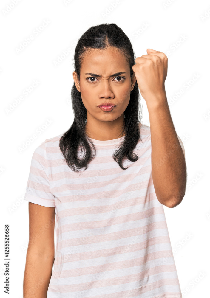 Young Filipina woman showing fist to camera, aggressive facial expression. Young Filipina woman showing fist to camera, aggressive facial expression.