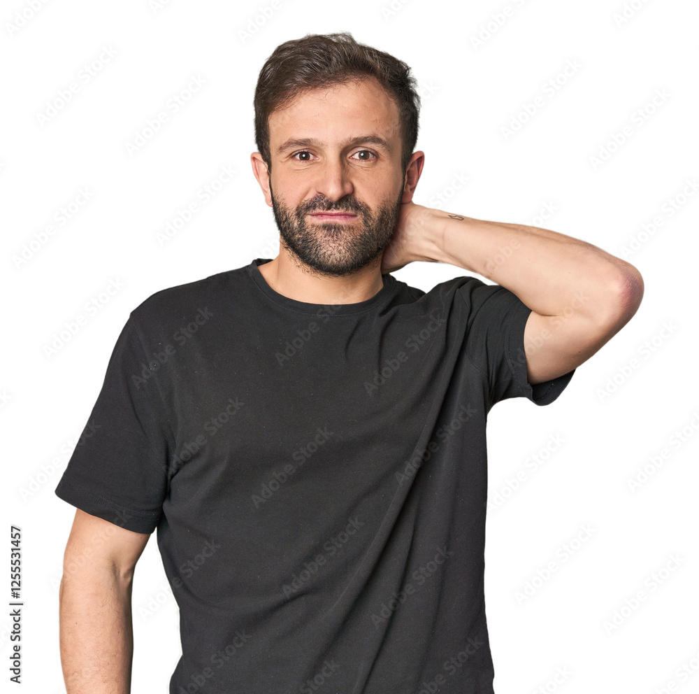 Fototapeta premium Studio portrait of young Hispanic male touching back of head, thinking and making a choice.