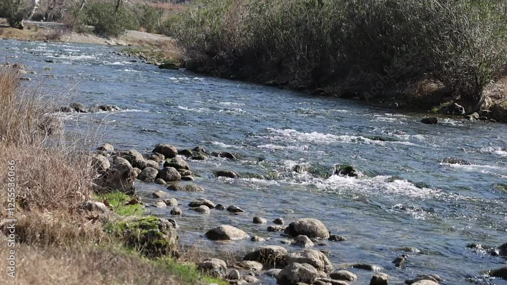 A serene scene of a river meandering slowly through a picturesque natural setting A serene scene of a river meandering slowly through a picturesque natural setting