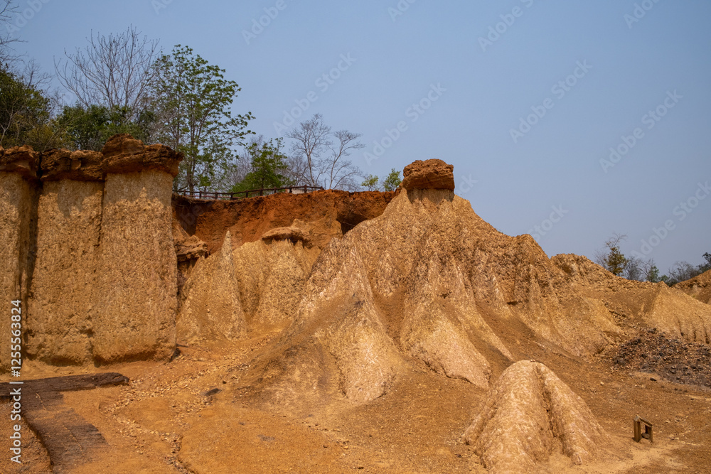 Stunning rock formations at Phae Mueang Phi Forest Park in Phrae, Thailand. A unique geological wonder with rugged sandstone pillars shaped by natural erosion. Stunning rock formations at Phae Mueang Phi Forest Park in Phrae, Thailand. A unique geological wonder with rugged sandstone pillars shaped by natural erosion.