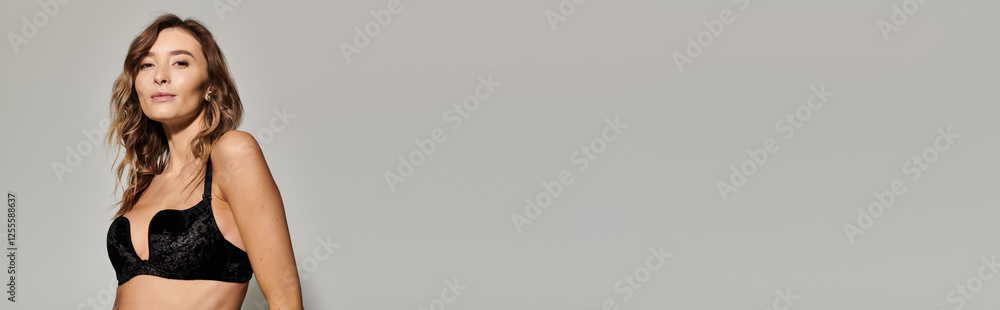 Fototapeta premium Chic young woman showcasing trendy lingerie style in elegant indoor setting