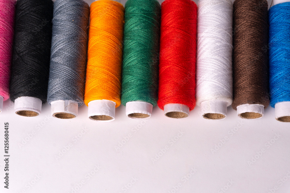 Colorful sewing thread set and needles isolated on background.
Colorful sewing thread set and needles isolated on background.