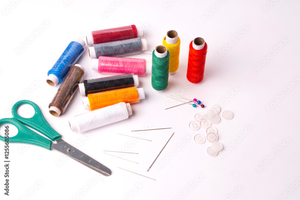 Colorful sewing thread set and needles isolated on background.
Colorful sewing thread set and needles isolated on background.