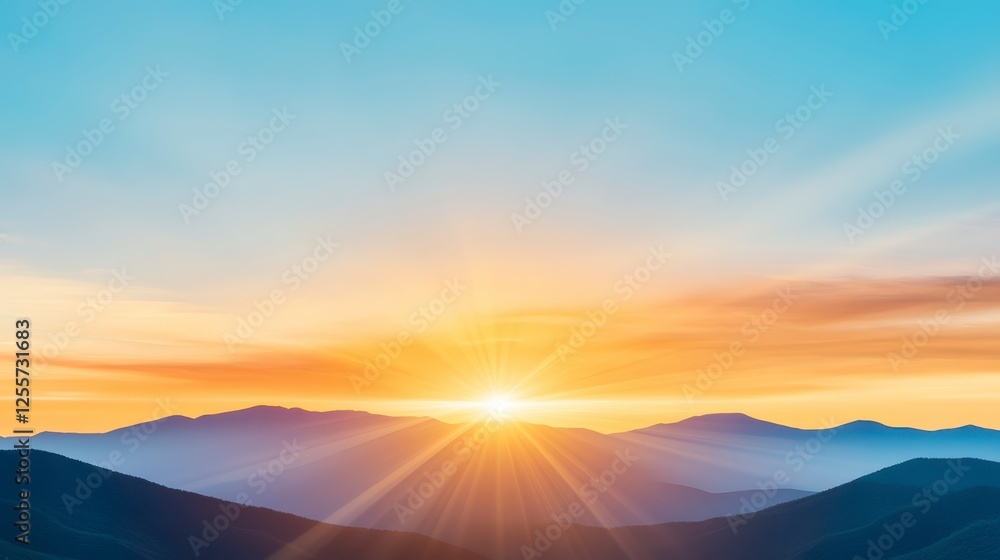Obraz premium Panoramic view of a vibrant sunset over a mountain range. Soft, golden, orange, and blue hues paint the sky. The sun is prominent in the center
