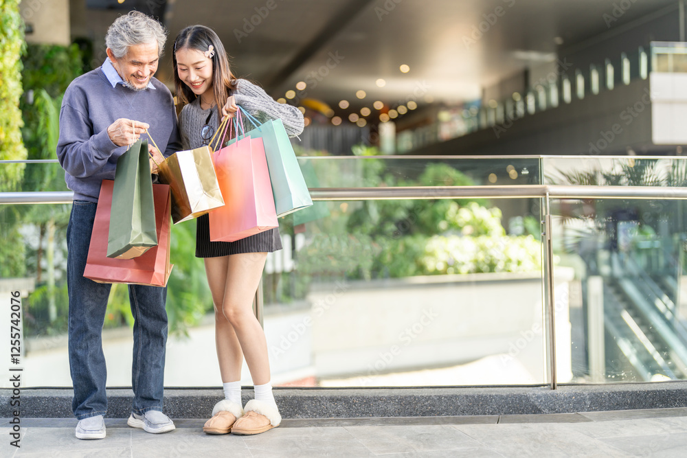 Father and daughter happy excited shopping together checking items in shopping bags, family joy, retail, sale, store experience, discounts, weekend shopping relationship unpacking gifts at mall Father and daughter happy excited shopping together checking items in shopping bags, family joy, retail, sale, store experience, discounts, weekend shopping relationship unpacking gifts at mall