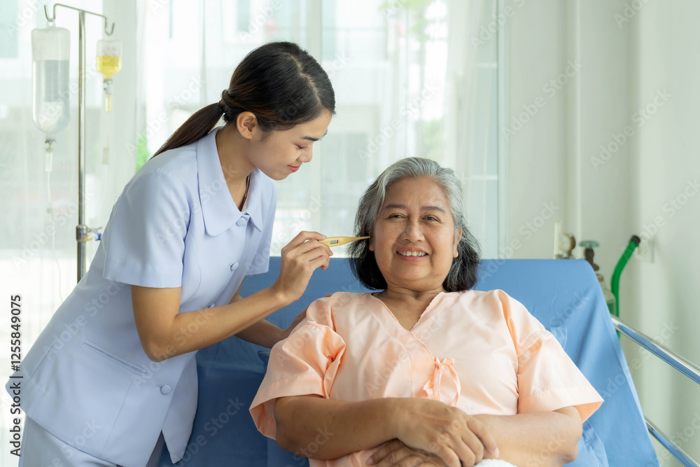 Obraz premium Asian nurse wearing a light purple uniform attentively taking care of an elderly Asian woman inhospital gown, measuring her temperature with a thermometer while smiling warmly in a clean hospital room