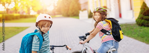 Φωτογραφία Boy and girl on the bicycles riding together.