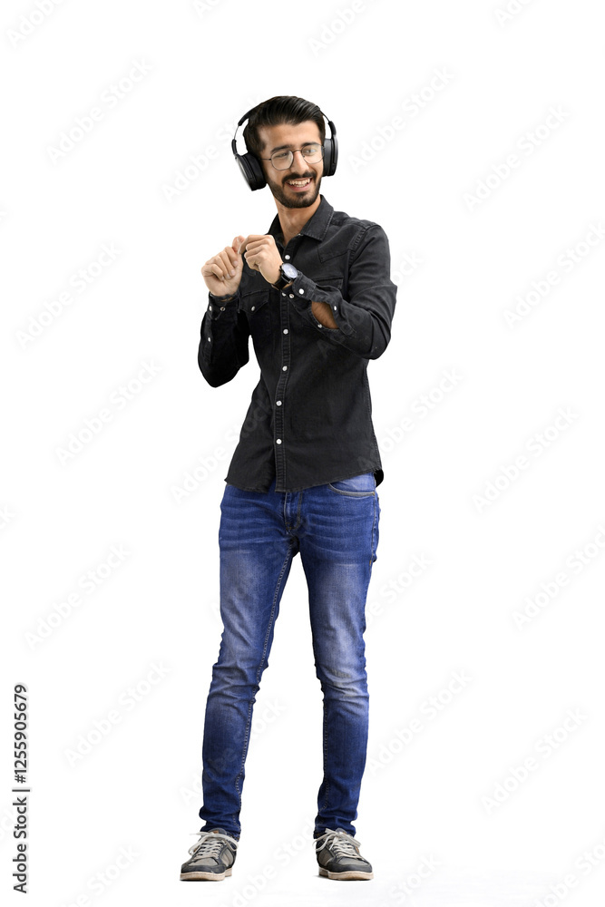 Man, on a white background, full-length, wearing headphones Man, on a white background, full-length, wearing headphones