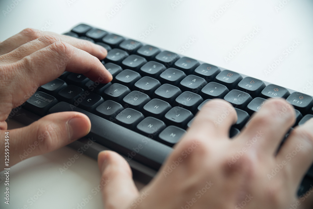 Close up of a man's hands on keyboard of lap top in the dark room, people working at home, modern white notebook. Internet, work, technology concept. Close up of a man's hands on keyboard of lap top in the dark room, people working at home, modern white notebook. Internet, work, technology concept.