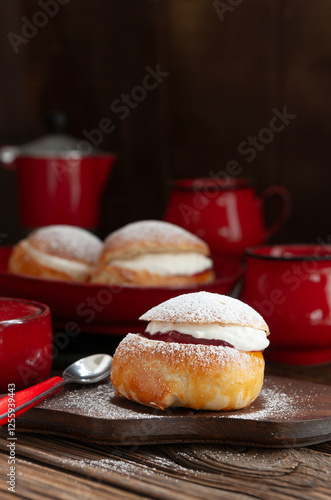 Homemade Semla or semlor, vastlakukkel, laskiaispulla - traditional Scandinavian  sweet bun especially Fastelavn Shrove Monday and Shrove Tuesday photo