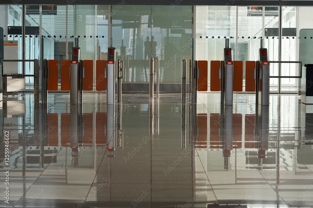 Modern airport security gates and reflective floor illuminated by morning light. Perfect for showcasing airport facilities, security systems, and the seamless flow of passengers in transport hubs Modern airport security gates and reflective floor illuminated by morning light. Perfect for showcasing airport facilities, security systems, and the seamless flow of passengers in transport hubs