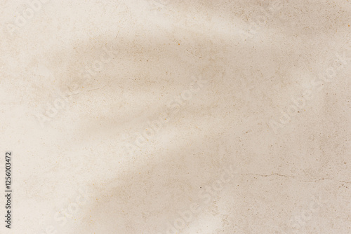 Soft shadows of tropical palm leaves on textured concrete background neutral beige colored. Summer travel, vacation, spa concept. Minimal style photography, summertime aesthetic backdrop copyspace
