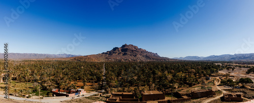 Travel destination Morocco, palm tree grove and mountain area, amazing oasis. photo