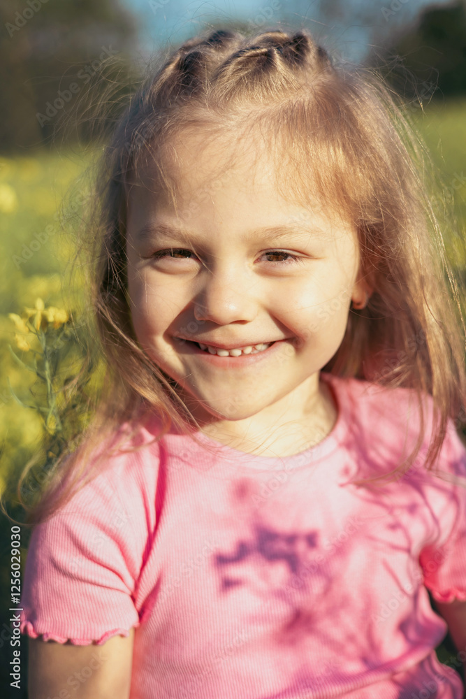Close-Up Portrait of a Happy Little Girl in a Flower Field Close-Up Portrait of a Happy Little Girl in a Flower Field