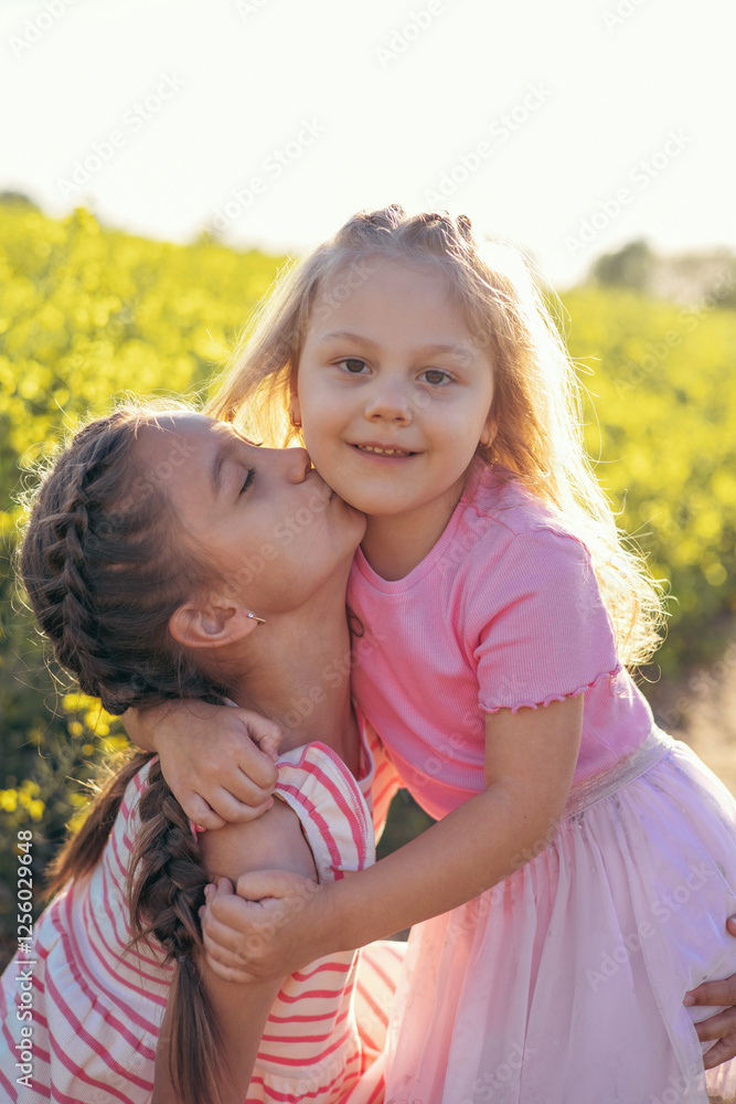 Sisters Sharing a Loving Kiss in a Sunlit Field Sisters Sharing a Loving Kiss in a Sunlit Field