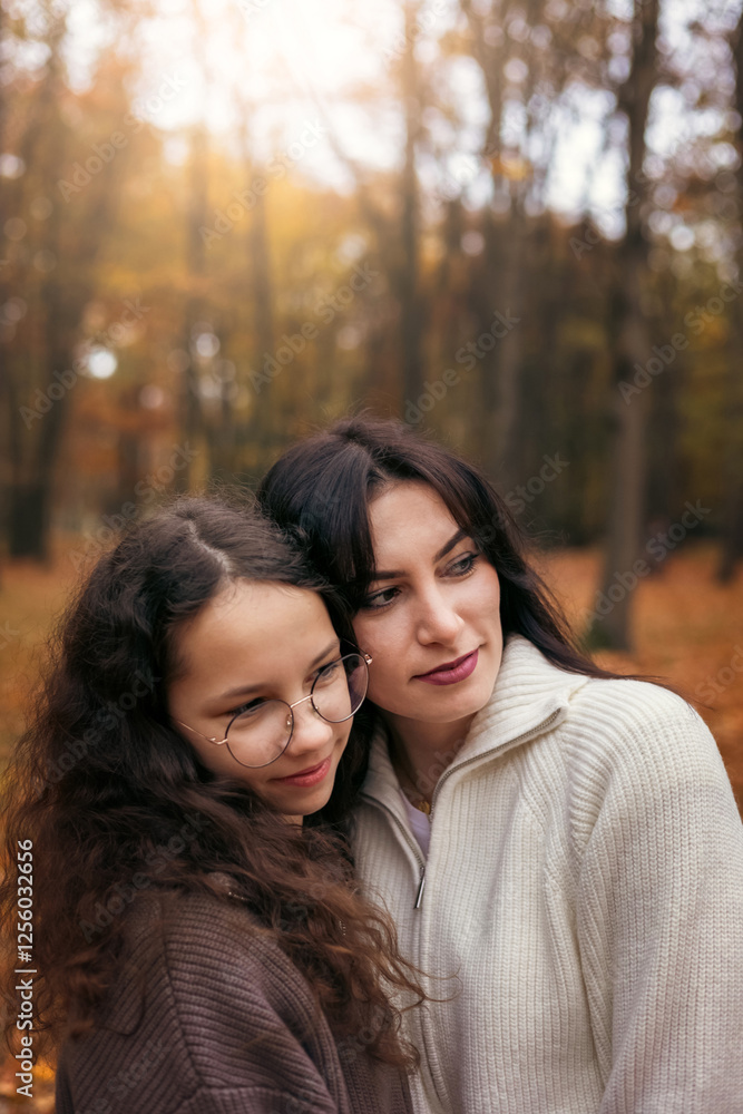 Mother and daughter enjoying a cozy autumn walk outdoors Mother and daughter enjoying a cozy autumn walk outdoors