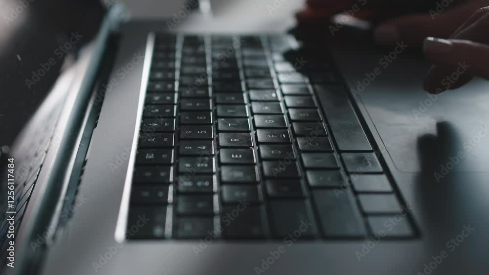 Close-up of a laptop keyboard with hands typing, focused on the task at hand. The concept of productivity and technological flow of work in the modern world. Close-up of a laptop keyboard with hands typing, focused on the task at hand. The concept of productivity and technological flow of work in the modern world.