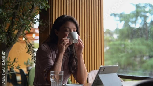 Beautiful woman drinking coffee in coffee shop