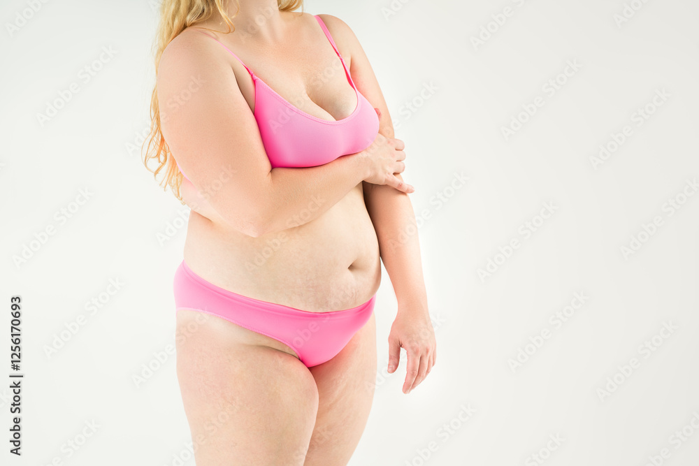 Naklejka premium Fat woman in pink underwear on gray background, overweight female, obesity body, weight loss concept