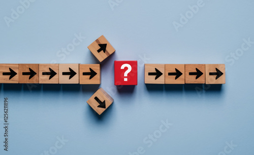 Question mark print screen on red wooden block cross in the middle of arrow for interrupt of process concept. 
