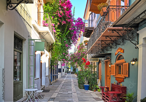 Fototapeta Naklejka Na Ścianę i Meble -  Narrow streets of Nafplion town with Bougainvillea flowers