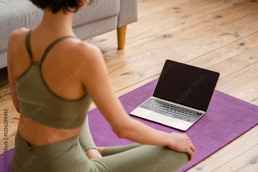 Fototapeta premium young pretty woman doing yoga at home