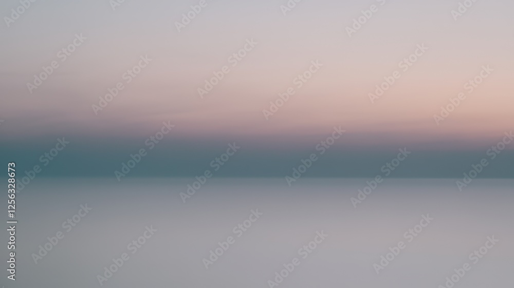 Obraz premium A serene gradient of pastel colors spreads across the horizon, blending hues of soft blue, pink, and lavender over a calm water surface.
