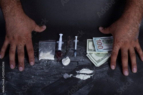 Canvas Print Man's hands trying to abstain from drugs on dark table with cookedcocaine