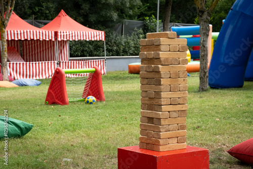 A big stack of wooden blocks in a kids playground, outdoors.