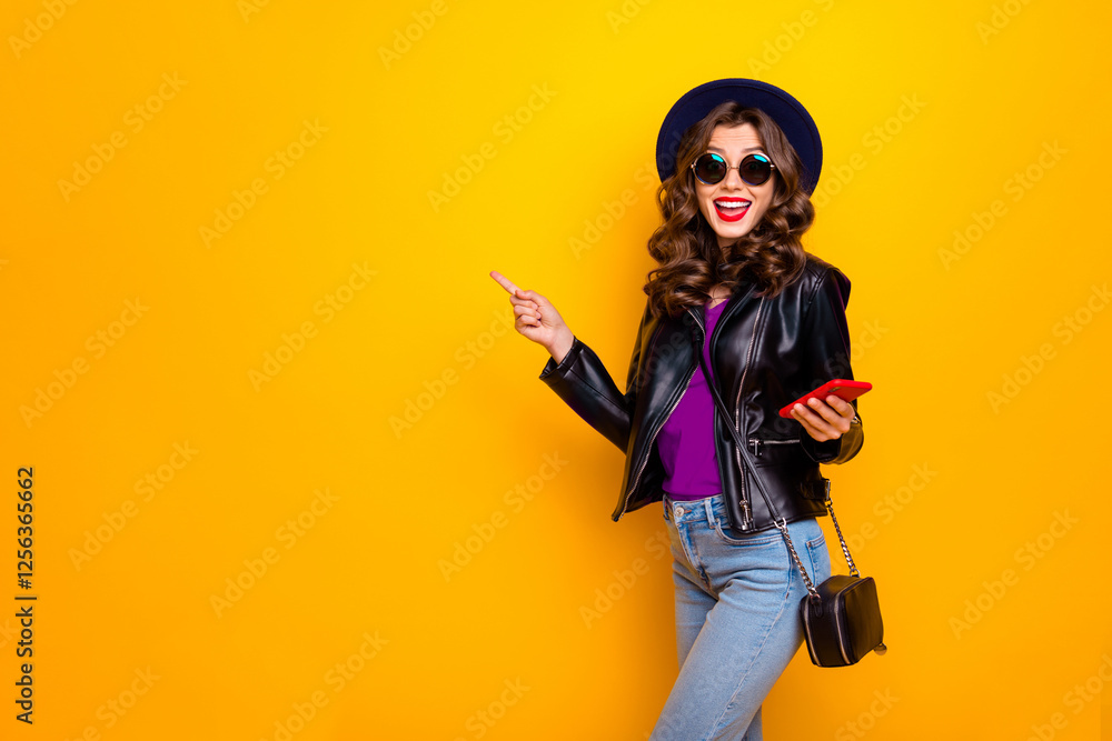 Portrait of excited shocked surprised girl with wavy hairstyle follow comment promo discount scream wow omg wear black leather jacket isolated over yellow color background Portrait of excited shocked surprised girl with wavy hairstyle follow comment promo discount scream wow omg wear black leather jacket isolated over yellow color background