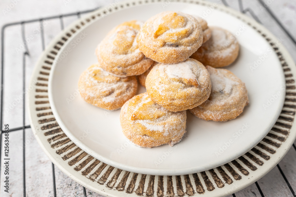 Italian cherry sugar cookies on a white plate. Powder sugar covered cookies. Italian cherry sugar cookies on a white plate. Powder sugar covered cookies.