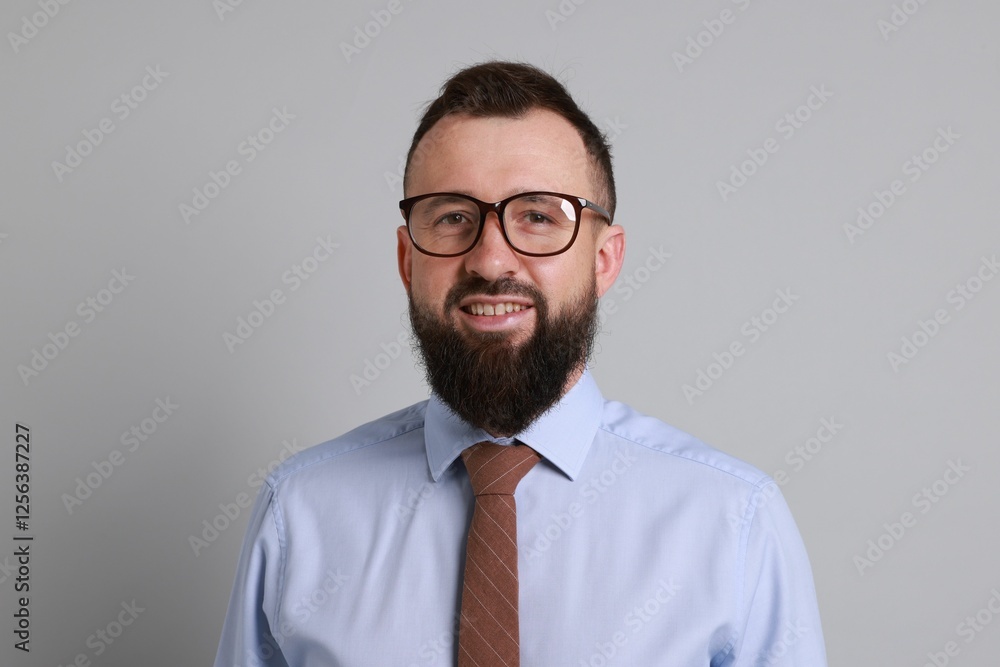 Handsome bearded man in formal outfit on grey background Handsome bearded man in formal outfit on grey background