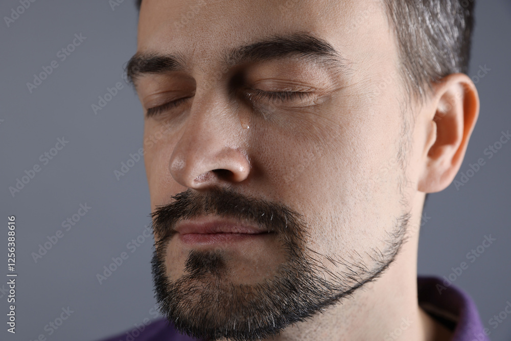 Sad man crying on grey background, closeup Sad man crying on grey background, closeup