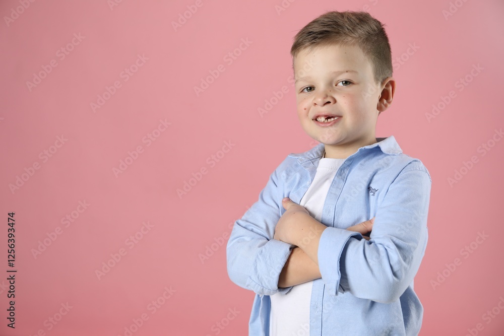 Cute little boy with missing tooth on pink background, space for text Cute little boy with missing tooth on pink background, space for text