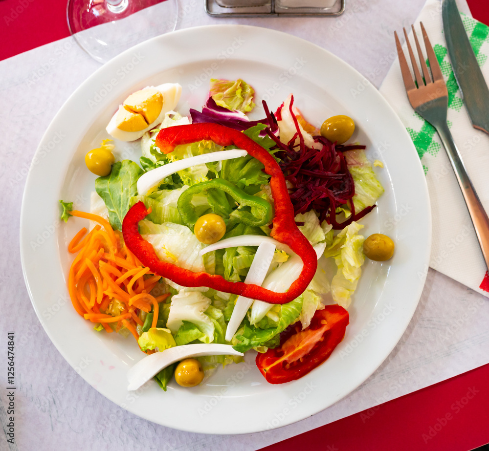 Summer salad with bell peppers, olives, carrots, boiled eggs and tomatoes Summer salad with bell peppers, olives, carrots, boiled eggs and tomatoes
