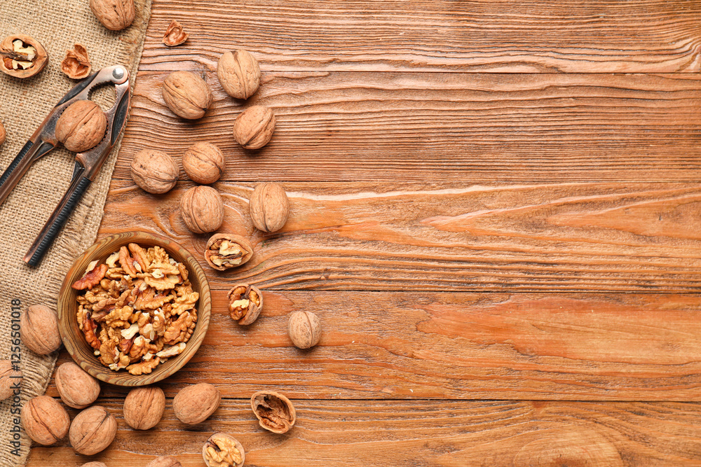 Bowl with walnuts and nutcracker on wooden background Bowl with walnuts and nutcracker on wooden background