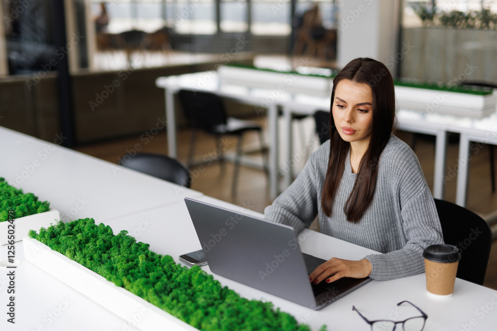 Young woman on working over the laptop, sitting at the home office. Young woman on working over the laptop, sitting at the home office.