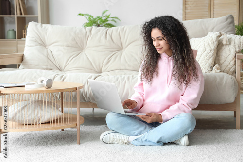 Remote work and digital lifestyle, young woman using laptop on living room fl...
