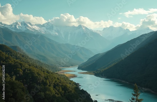 Wallpaper Mural Majestic mountain range with snowy peaks under sky. Serpentine river winds through valley surrounded by green forest hills. Scenic landscape evokes tranquility, adventure, escape. Perfect background Torontodigital.ca