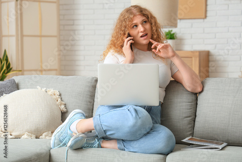 Young woman with laptop tal...