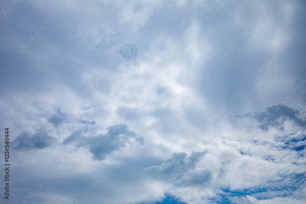 Fototapeta premium The Dramatic and Beautifully Cloudy Sky with Hints of Blue Peeking Through the Clouds