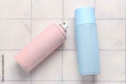Spray paint cans on tile ba...