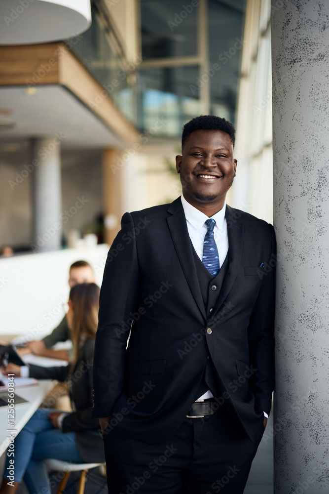Confident Businessman Smiling in Modern Office Environment Confident Businessman Smiling in Modern Office Environment