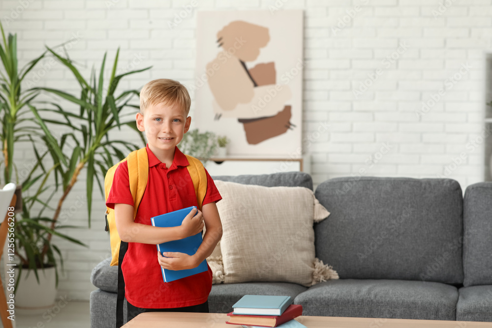 Cute little boy with backpack and book at home Cute little boy with backpack and book at home