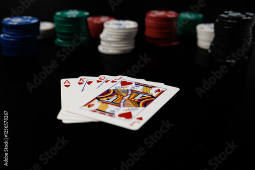 Poker cards and betting casino chips on a black background. Card game gambling. photo